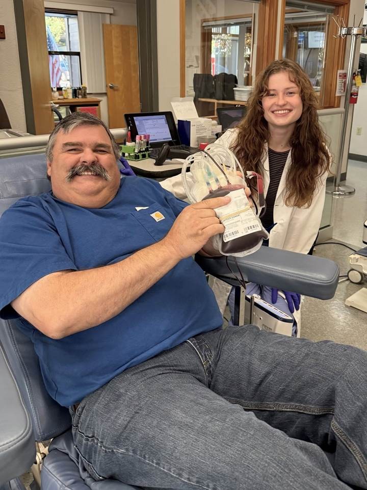 Donor and phlebotomist during a whole blood donation