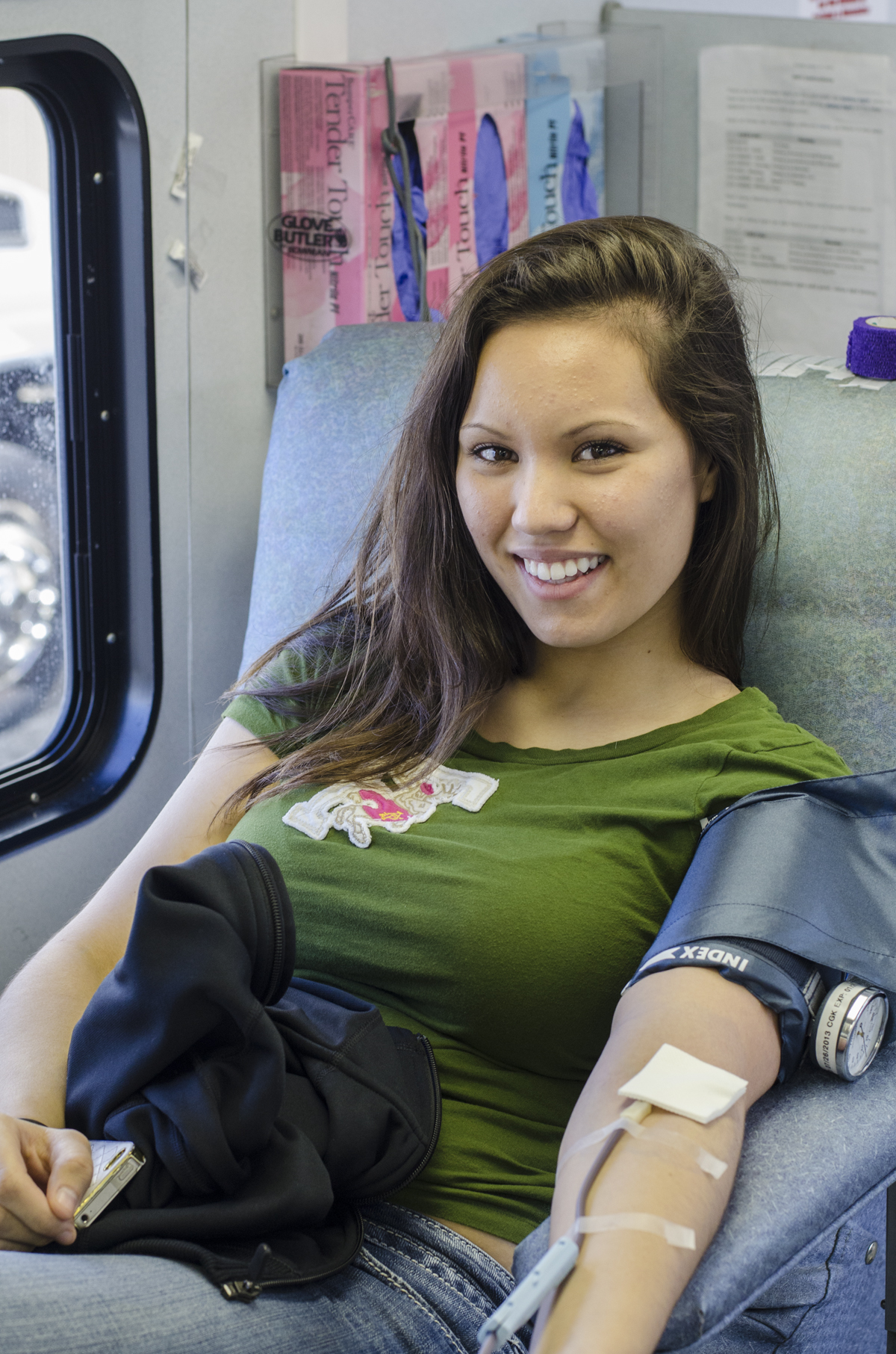 A donor giving blood in the chair aboard the Bloodmobile