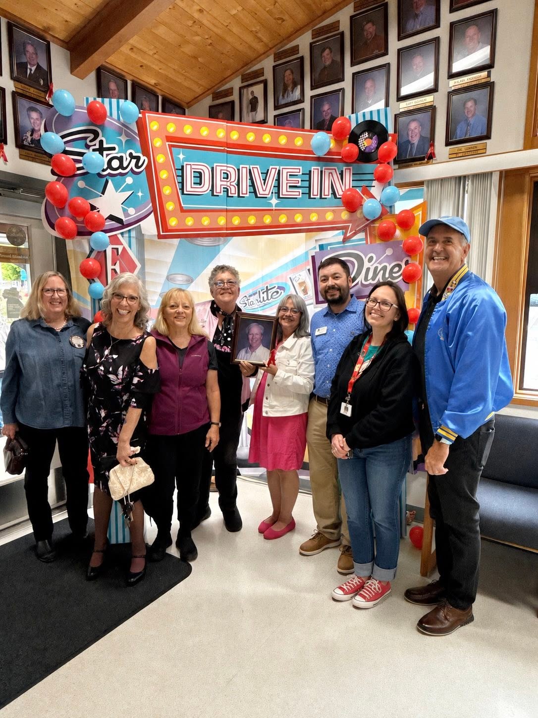 Staff and community members at a drive-in themed community event